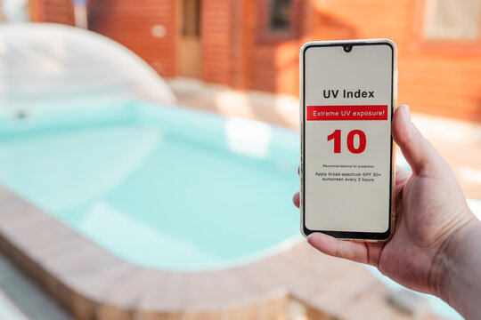 Checking UV exposure on a phone app before going to the swimming pool.