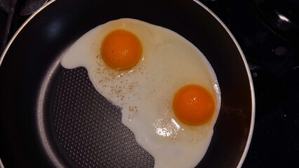 Fried Egg with ingredient in cast iron frying pan, on old dark wooden table background, top view flat lay , with space for text copyspace