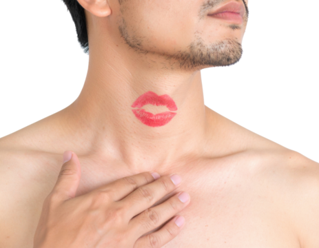 A shirtless man with facial hair has a red lipstick kiss mark on his neck and his hand resting on his chest against a black background. - Powered by Adobe