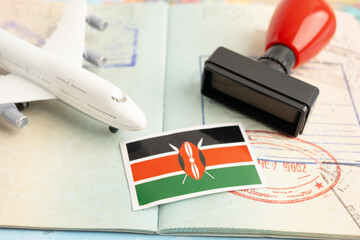 Kenya flag and passport with airplane for travel.