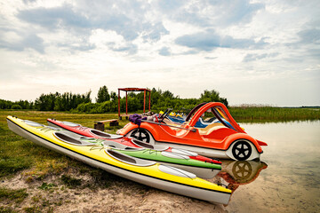 Kayaks on the lake shore, summer vacation on the lake.