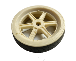 A small vintage plastic toy wheel with a black rubber tire is isolated on white isolated on transparent