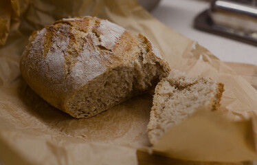 Freshly baked bread cut on a baking paper