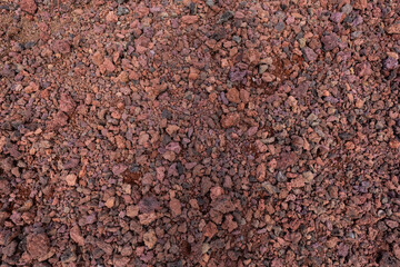Naklejka premium Looking down at soil with red color.