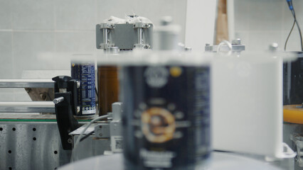 Automated labeling machine applying labels to coffee cans on a production line in a modern factory, ensuring consistent branding and product information