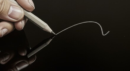 Hand Drawing Line with Graphite Pencil on Reflective Black Surface, Close-Up
