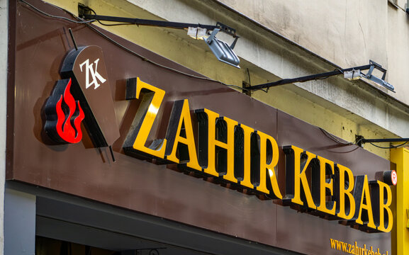 Zahir Kebab restaurant sign with distinctive logo and website address on a brown facade.