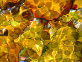 An illustrative image of the physical phenomena of reflection and refraction of light when it hits water with a multicoloured back