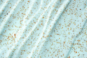 The texture of a mint body scrub with particles. Close-up