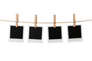 Four empty instant camera photos clipped to twine rope with natural wood clothespins, isolated on a transparent background