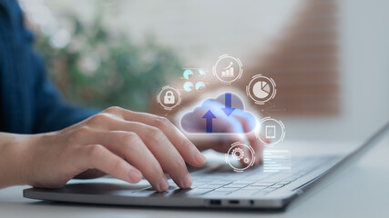 Close-up of hands typing on a laptop with cloud computing icon showing secure data upload and...