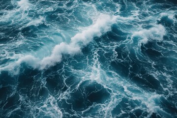 Fototapeta premium Turbulent Deep Blue Sea Water with Frothy White Waves, Showcasing the Raw Energy and Beautiful Abstract Textures of the Marine Environment