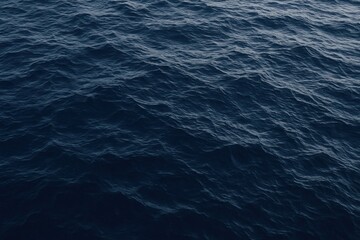 Contemplative view of the deep blue ocean's endless surface texture and gentle swell