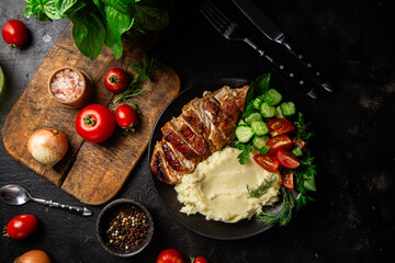 Deliciously Grilled Chicken Breast Slices Served with Mashed Potatoes and Salad