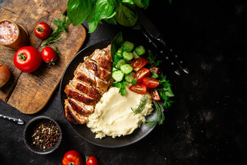 Deliciously Grilled Chicken Breast Slices Served with Mashed Potatoes and Salad