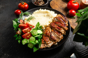 Deliciously Grilled Chicken Breast Slices Served with Mashed Potatoes and Salad