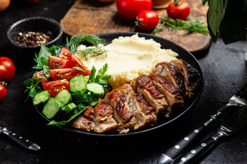 Deliciously Grilled Chicken Breast Slices Served with Mashed Potatoes and Salad