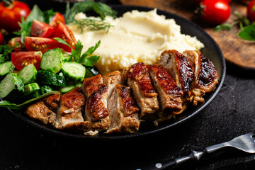 Deliciously Grilled Chicken Breast Slices Served with Mashed Potatoes and Salad