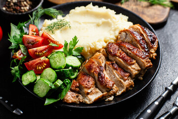 Deliciously Grilled Chicken Breast Slices Served with Mashed Potatoes and Salad