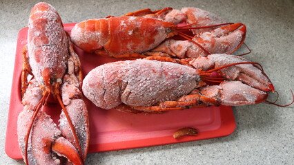 Boiled Frozen Lobsters on a Red Cutting Board