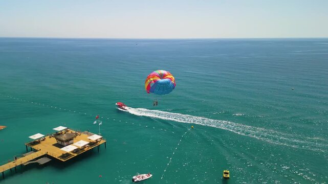 parasailing in the mediterranean sea - drone view