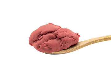 a scoop of red ice cream on a wooden spoon