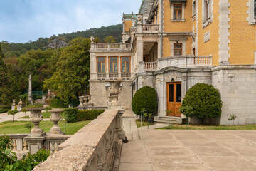 Massandra Palace of Emperor Alexander III. Historic mansion with ornate stonework and balconies, surrounded by lush greenery, exuding timeless elegance and charm. Yalta, Crimea - September 30, 2019
