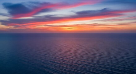 Fototapeta premium Serene Ocean Vista at Sunset: A breathtaking panorama of calm waters and vibrant sky