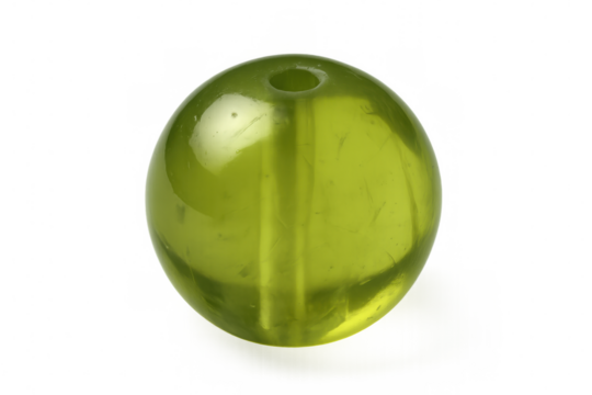 Glass bead reflecting light, lime green translucent sphere with polished surface against transparent background in professional studio setting