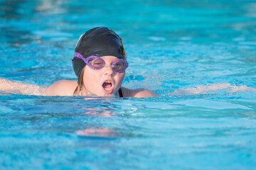 Young Girl Lears to Swim Butterfly Stroke
