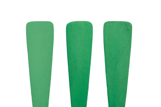three green spatensils are shown on a white background