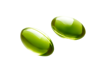 two green oval shaped pills on a white surface