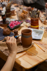 12. Spinning clay mug on potter’s wheel 