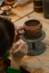 15. Unfinished clay cup on spinning wheel 