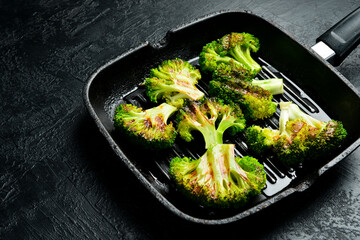 Organic green broccoli fried in a pan. Grill pan. Cooking healthy diet food.