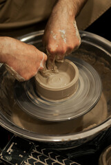 Clay vase forming on pottery wheel 