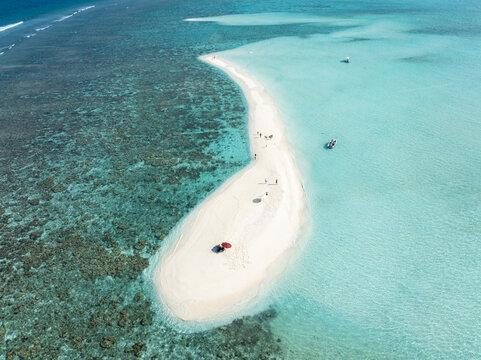 Aerial view of a pristine white sandbar meeting turquoise waters, a haven of tranquility under the Maldivian sun, Thoddoo, Alif Alif Atoll, Maldives.