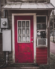 Red door on an old weathered building