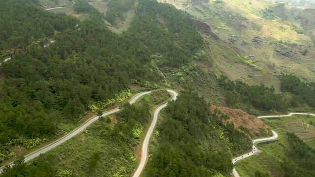 Motorbikes riding the Ha Giang Loop in Vietnam through the mountain hairpin ways
