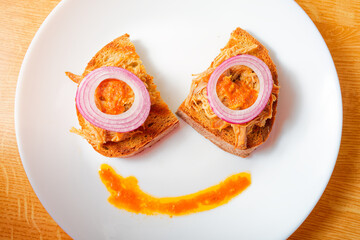 Pulled pork meat on bread - top view food face