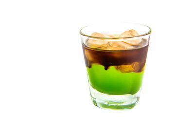 a green drink with ice cubes in it