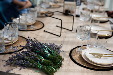 Table set for a meal with lavender decorations and elegant tableware