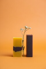 Handmade soap bars with natural ingredients for skincare and beauty on orange background