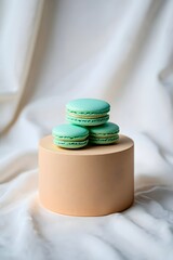 Delicious turquoise macarons stacked on a pedestal, perfect for dessert and pastry lovers