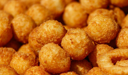 A pile of fried dough balls with a golden brown color