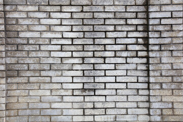 A brick wall with a grey color