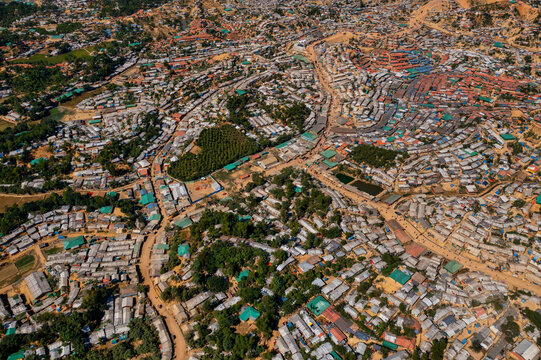 Aerial view of a sprawling settlement with densely packed structures and scattered greenery, Balukhali Bazar, Chittagong Division, Bangladesh.