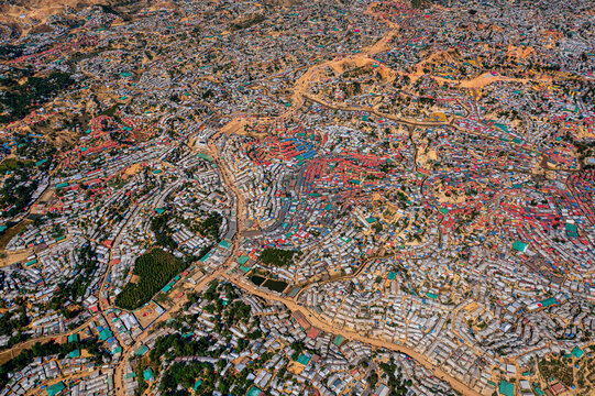 Aerial view of a sprawling landscape dotted with densely packed structures and winding pathways, Balukhali Bazar, Chittagong Division, Bangladesh.