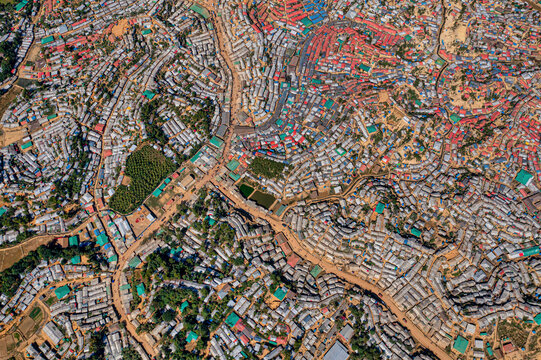 Aerial view of a densely packed refugee camp with buildings of various colors and materials, Balukhali Bazar, Chittagong Division, Bangladesh.