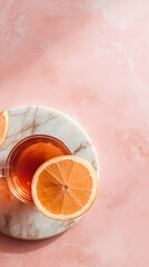 Refreshing orange drink on marble surface minimalist aesthetic soft pink background top view
